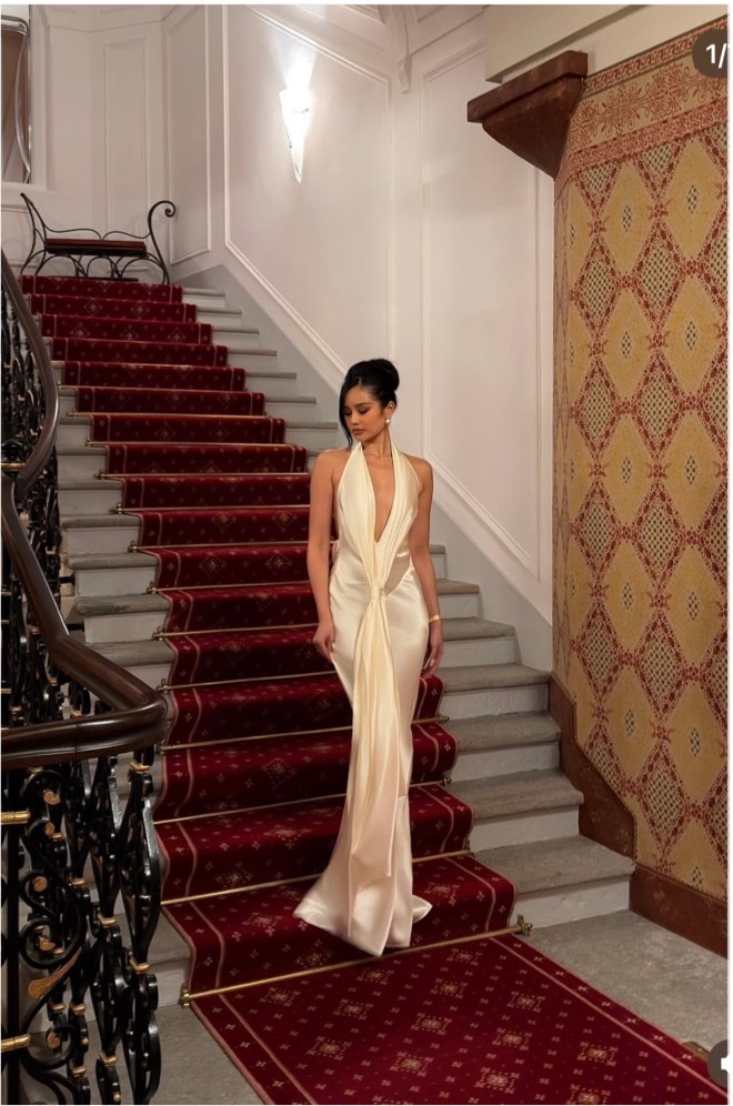 Pat Chaveesak (jarinpat) in a white evening gown on a palace staircase, winter season